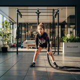 Roll Gear Tap Hype Pink Edition youth long-sleeve BJJ rash guard with black shorts and white socks.