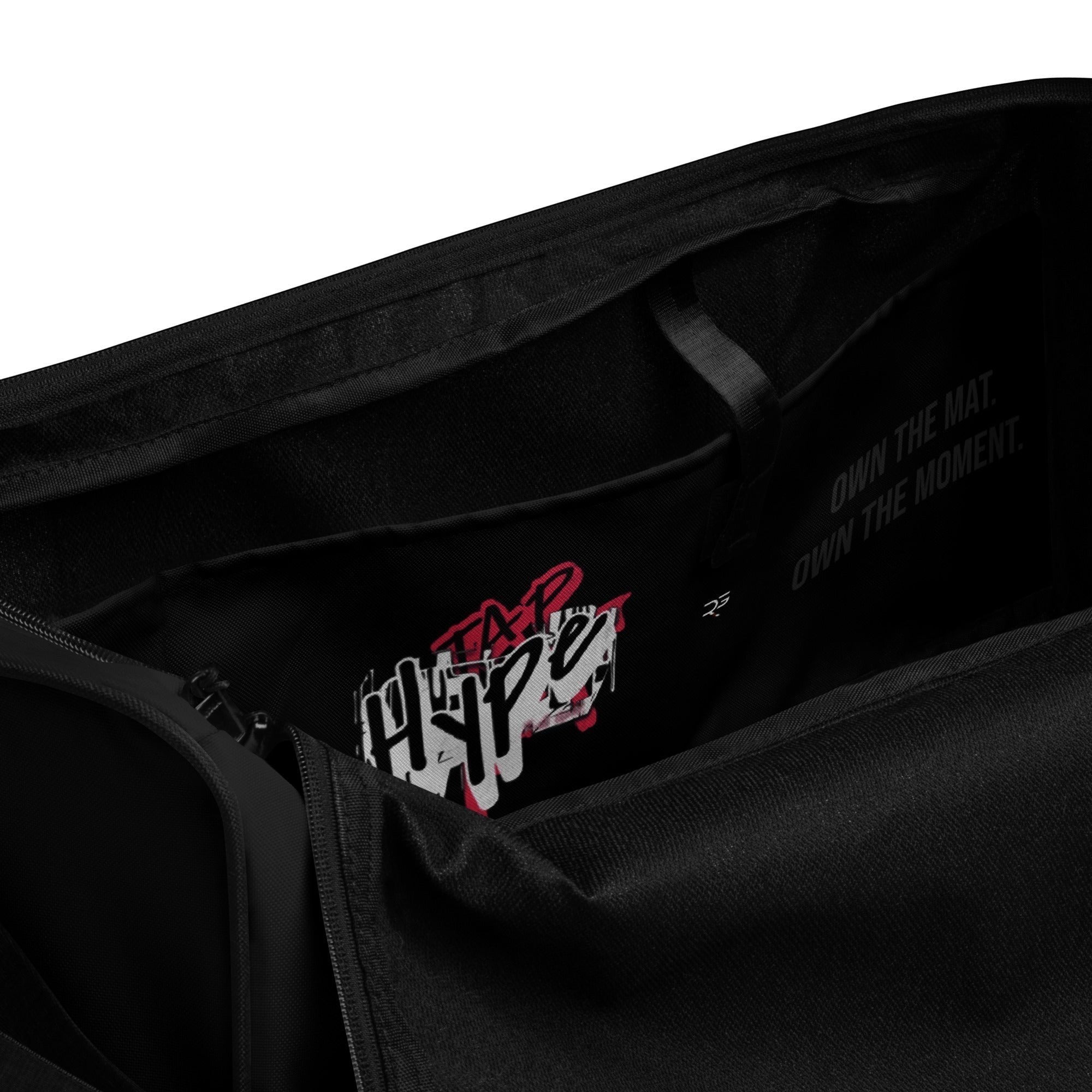Black polyester Tap Hype training duffel bag by Roll Gear LLC with bold graphic detail and motivational text.