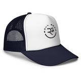 Roll Gear trucker hat with white front panel, navy mesh back, and embroidered logo.