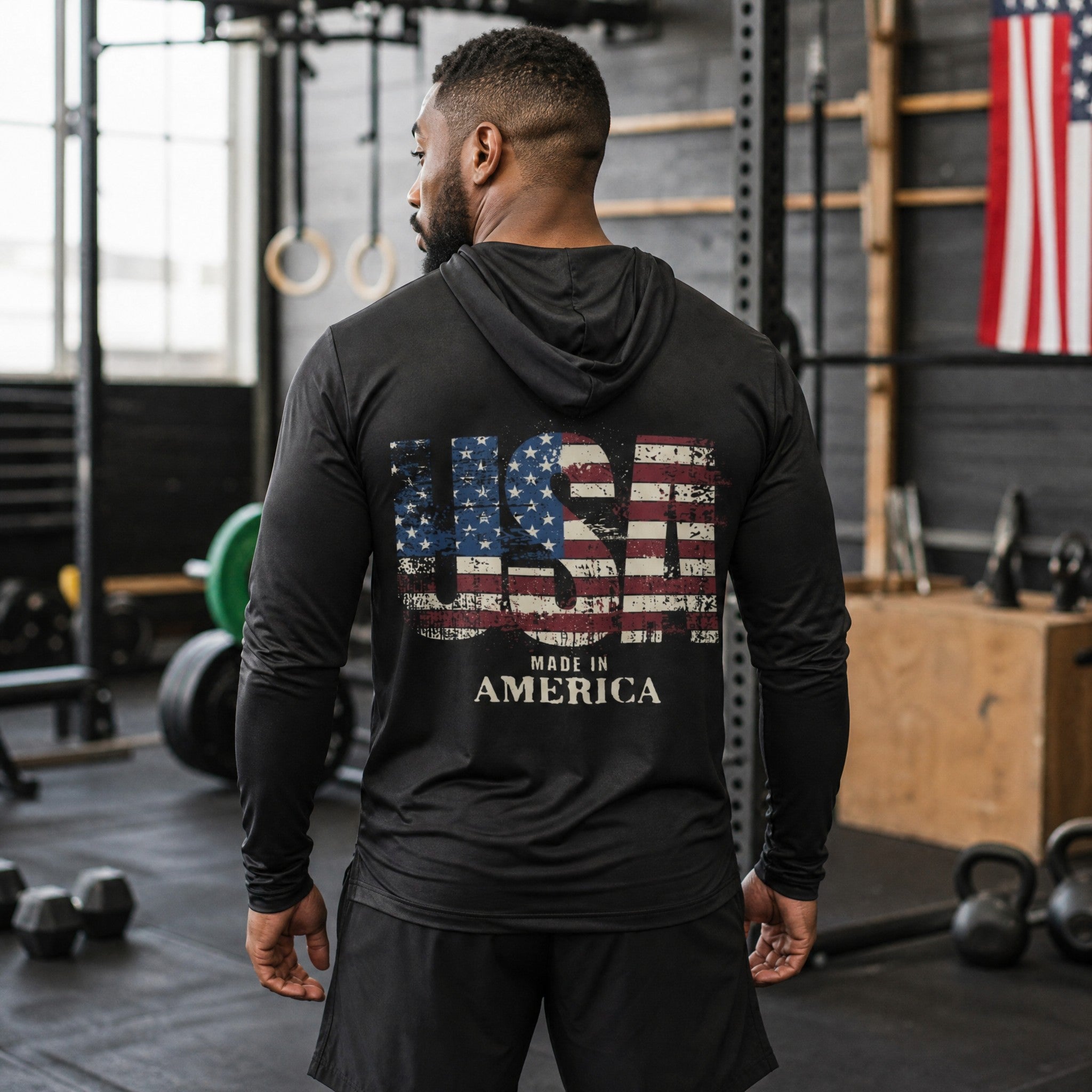 Roll Gear USA Performance Hooded Long Sleeve, back view on a man in a gym, USA graphic.