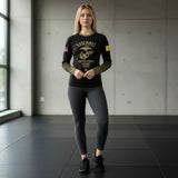 Roll Gear Youth Marines Gold military rash guard in black with faded gold sleeves and USMC emblem. Long sleeve, compression fit.