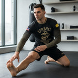 Roll Gear Men's black long sleeve rash guard with USMC graphic and camouflage sleeves. Model stretching.