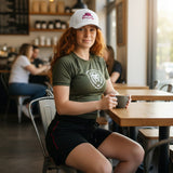 Roll Gear white structured baseball cap with pink embroidered BJJ belt graphic and "Girls on the Mat" text.