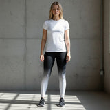 Roll Gear White Fade Training Spats – White/Black – Youth, worn by a model standing in a gym.