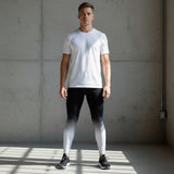 Roll Gear White Fade Training Spats – White/Black – Youth, worn by a model standing in a gym, front view.
