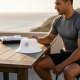 Roll Gear white 100% cotton twill bucket hat with embroidered logo, perfect for outdoor wear.