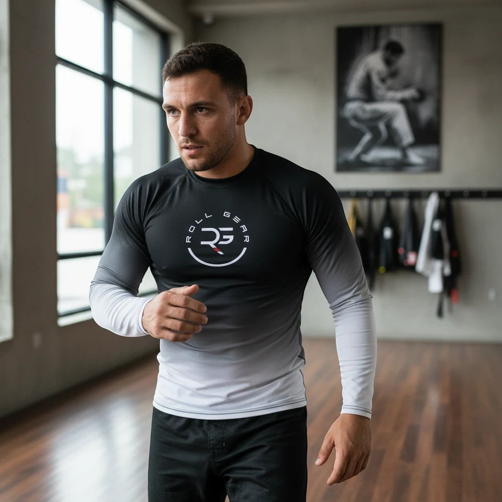 Roll Gear White Fade Long Sleeve Rash Guard – White/Black – Men’s, worn by a man moving in an academy.