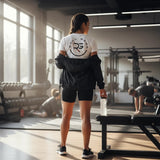 Roll Gear white premium t-shirt with blue gradient graphic on back, worn by a woman in a gym.