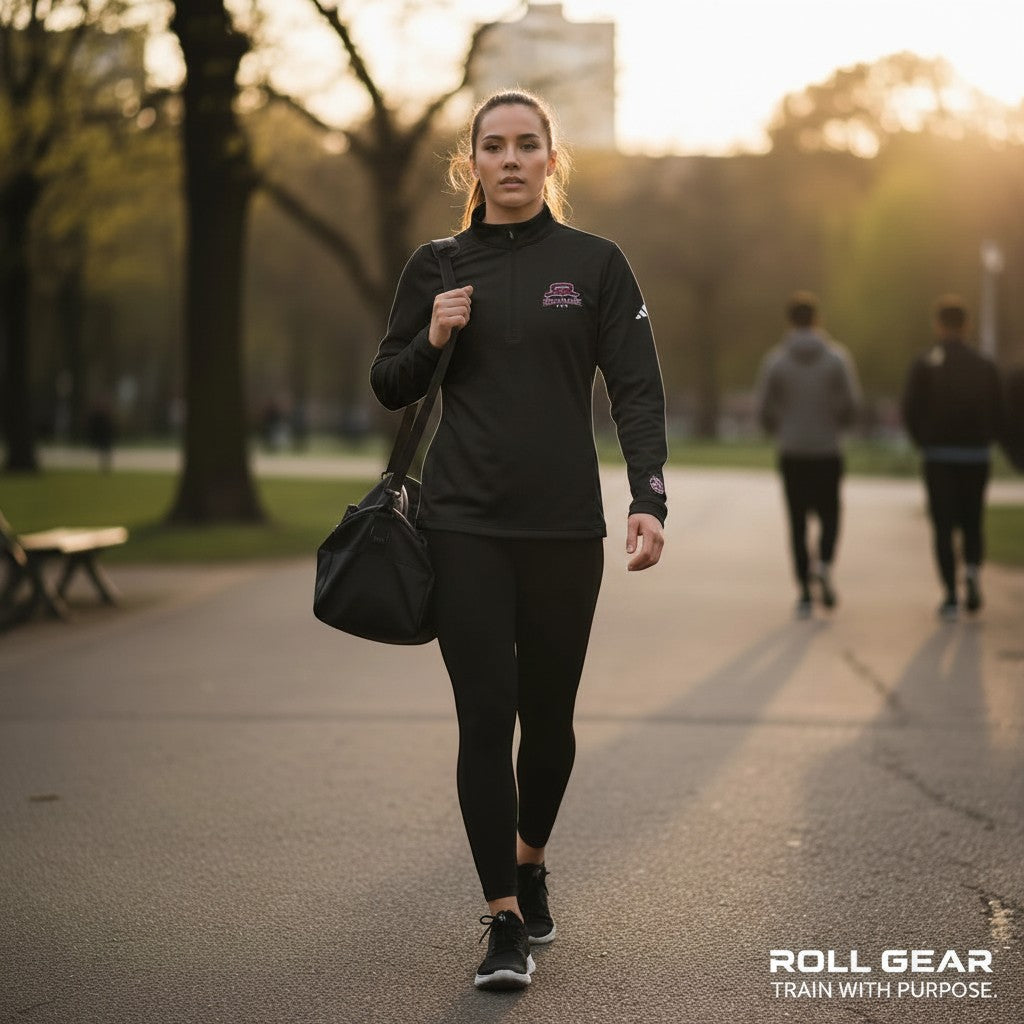 Roll Gear white polyester quarter zip pullover with embroidered logo on chest and sleeve. Women's athletic performance wear.