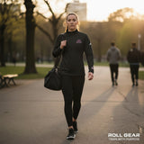 Roll Gear white polyester quarter zip pullover with embroidered logo on chest and sleeve. Women's athletic performance wear.
