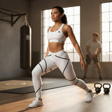 Roll Gear women's white microfiber spats with black swirl detailing and athletic waistband. Model is performing a lunge in a gym.