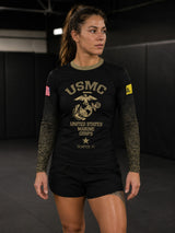 Roll Gear Women’s Marines Gold military rash guard in black with faded gold sleeves and USMC emblem. Compression fit, long sleeve.