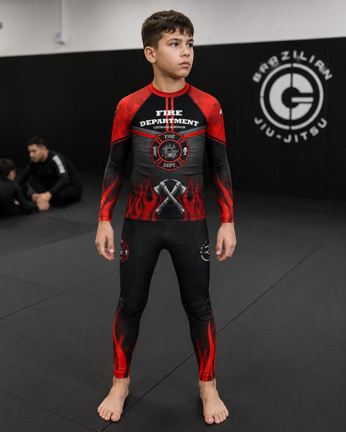 Roll Gear Youth Fire Department Compression Spats in black with red flames. Made of polyester and spandex for athletic training.