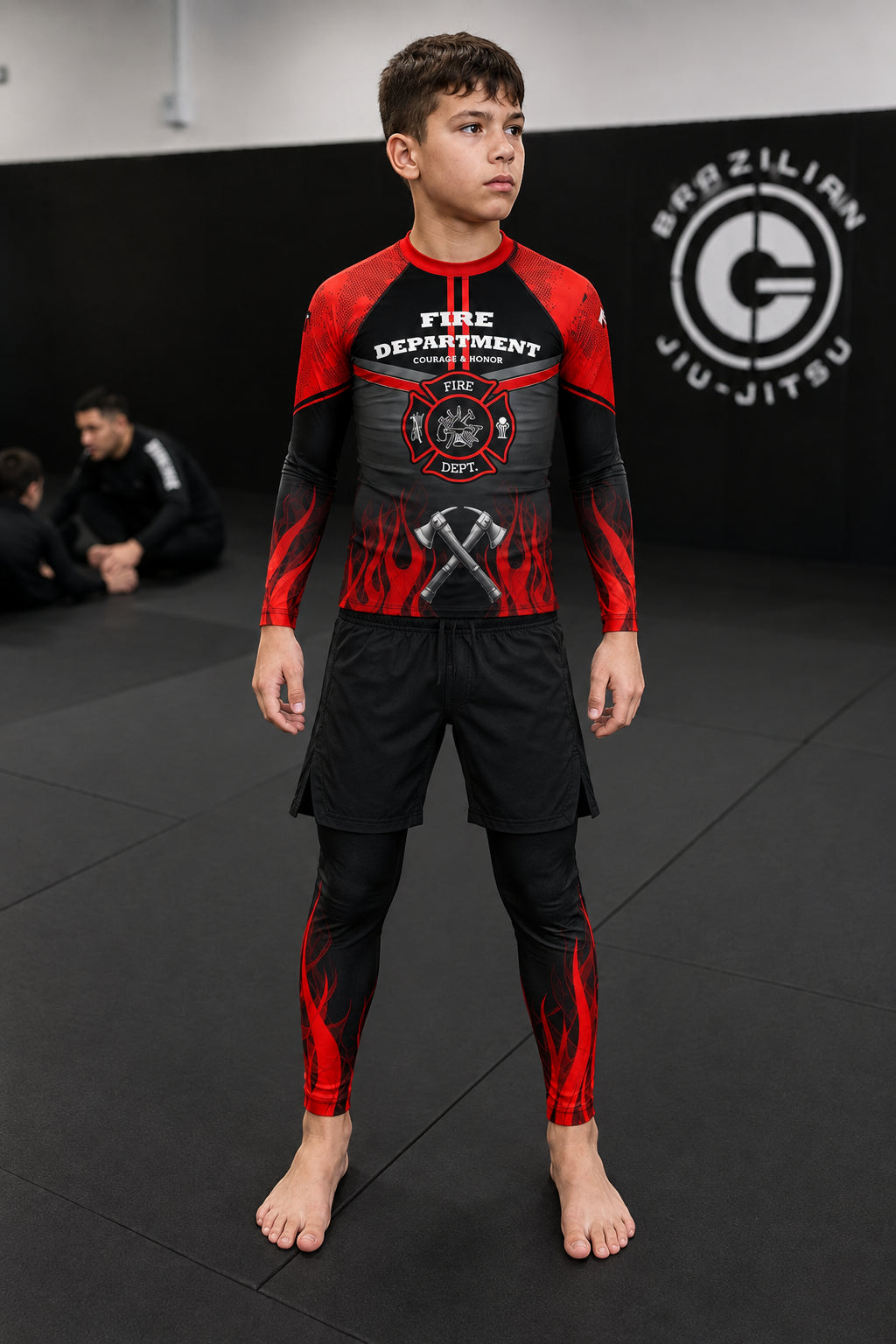 Roll Gear Youth Fire Department Compression Spats, black with red flames, worn by a boy.