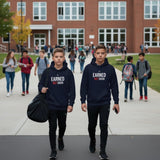 Roll Gear youth heavyweight navy blue hoodie with "Earned Not Given" graphic. Two boys walking outdoors.
