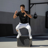 Roll Gear Tap Hype Youth BJJ Spats – Orange & White, teen boy jumping onto a plyo box.