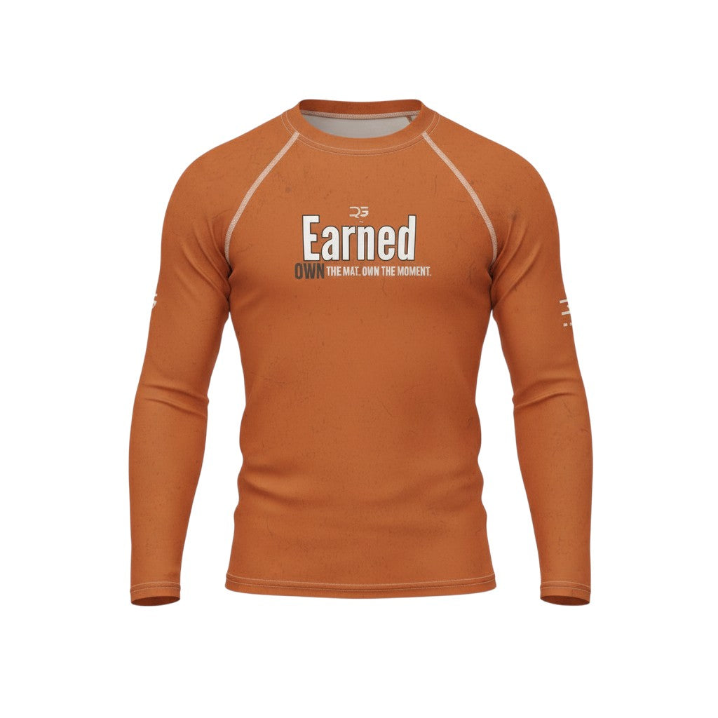Roll Gear Earned Not Given Long Sleeve Rash Guard – Burnt Orange, flat front view, Earned graphic.