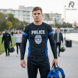 Roll Gear Men's black long sleeve rash guard with "POLICE" text, badge emblem, and blue accents. Compression fit for athletic training.