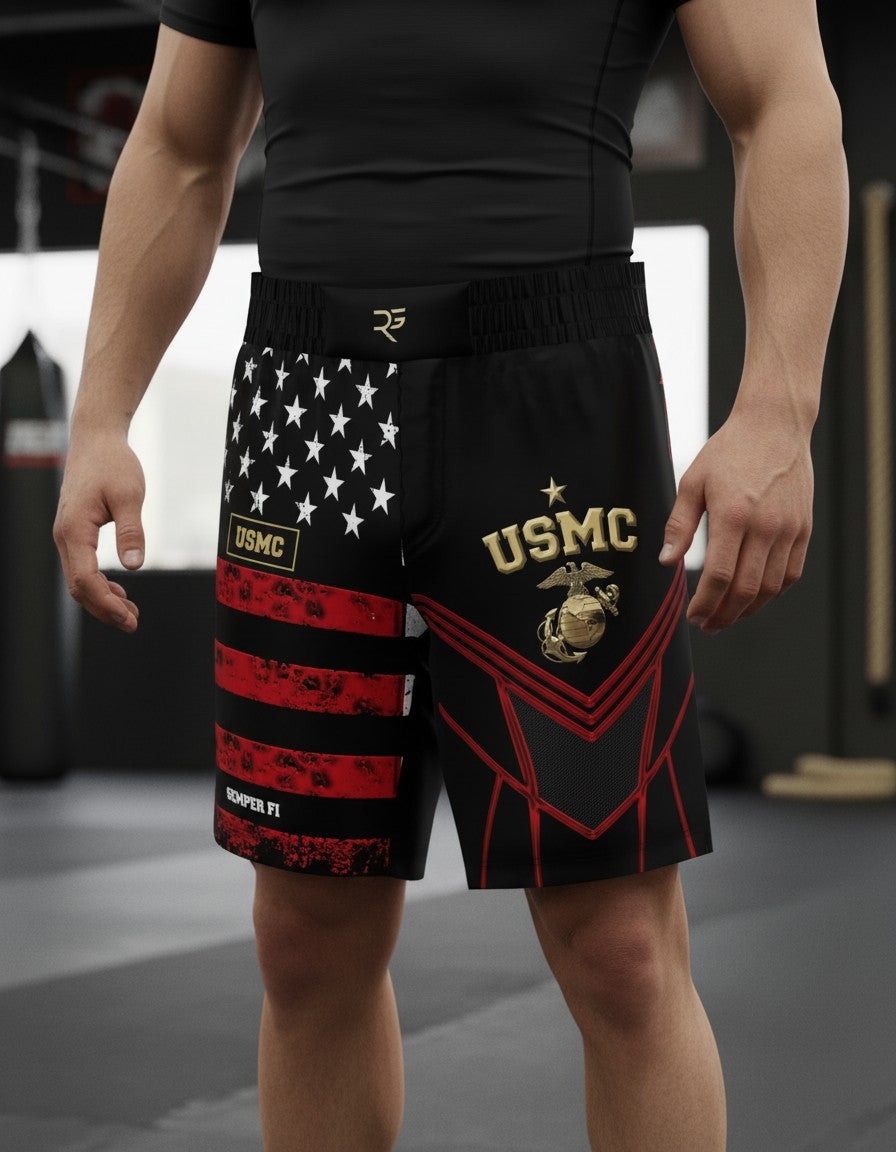 Roll Gear LLC USMC grappling shorts in black with US flag design on left leg and USMC emblem on right leg. Long cut.