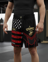 Roll Gear LLC USMC grappling shorts in black with US flag design on left leg and USMC emblem on right leg. Long cut.