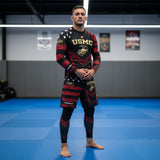 Roll Gear LLC USMC grappling shorts in black and red with USMC and Eagle Globe and Anchor graphics. Long cut with split leg for mobility.