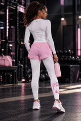 Roll Gear Tap Hype Spats – Pink & White – Youth Girls, back view with pink shorts in the gym.