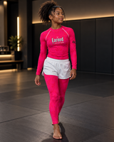 Roll Gear Earned Not Given Youth Spats – Pink, teen girl walking on the mat in the matching set.