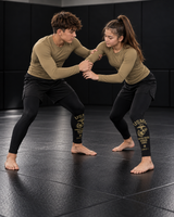 Roll Gear Youth Marines Gold Compression Spats, two teens hand fighting during drills.